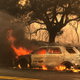Santa Barbara County Sheriff’s vehicle burning on Highway 154 east of Cachuma Lake in the Whittier fire east of Cachuma Lake in Santa Barbara County, California. (Image: AP)